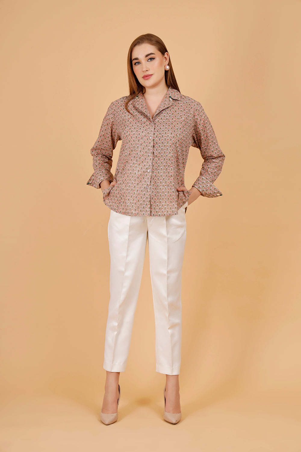 A beautifully blockprinted embellished chic cotton blouse, with white trousers.