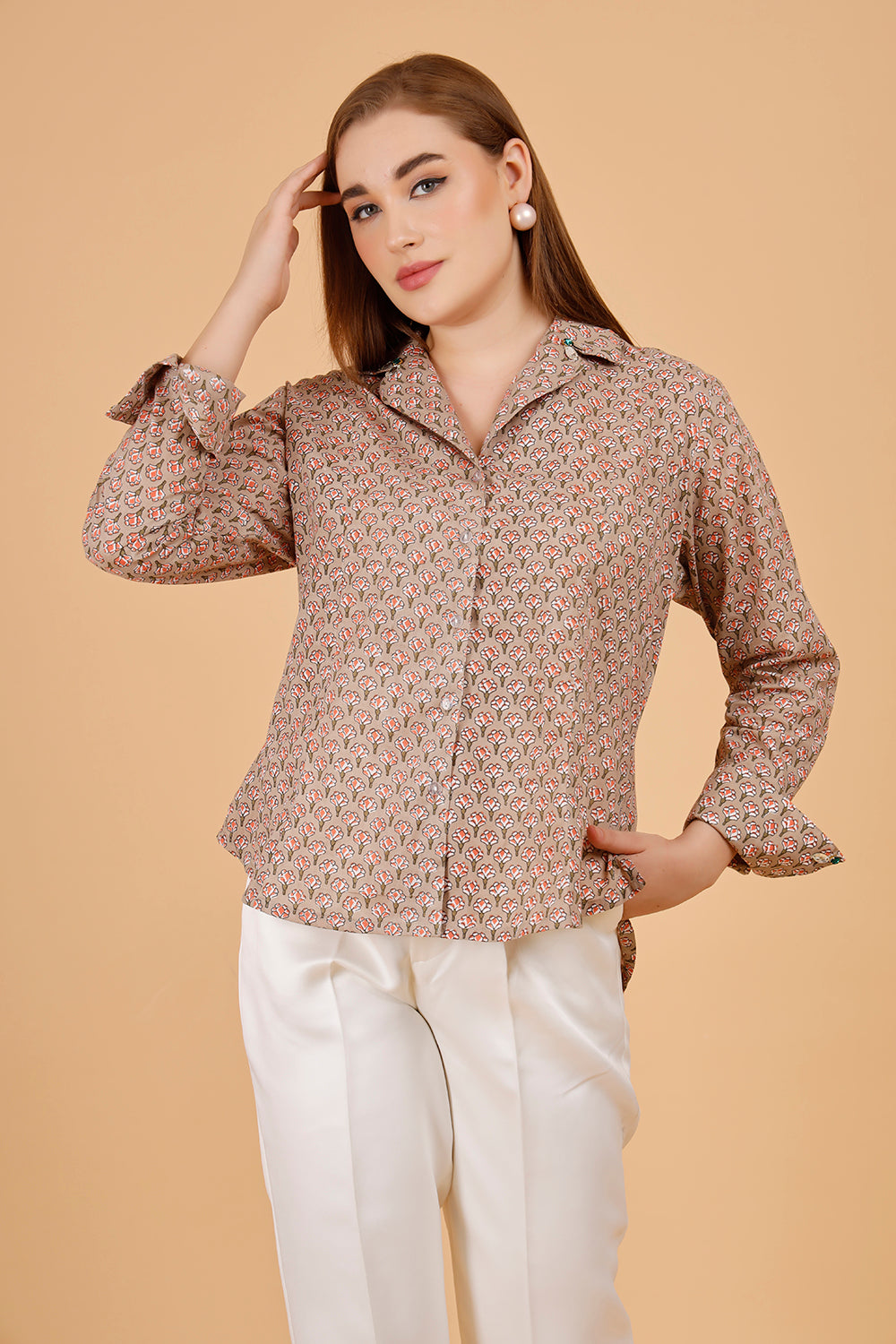 A beautifully blockprinted embellished chic cotton blouse, with white trousers.