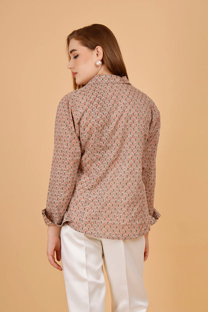 Back view of a beautifully blockprinted embellished chic cotton blouse, with white trousers.