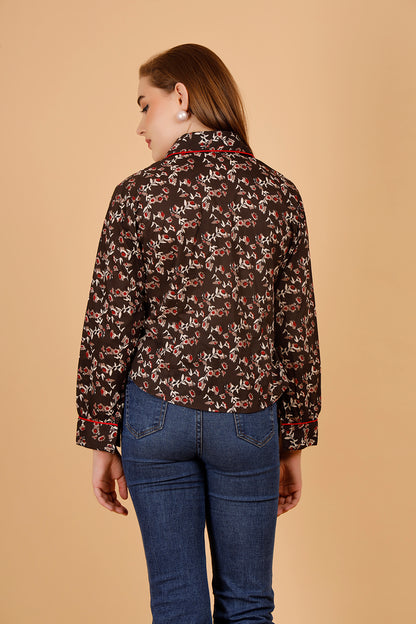 The model wears a comfortable womens blouse- a blockprinted cotton shirt, in colour brown, with red and beige jaipuri print, a structures short shirt for women, which is perfect for casual wear as well as office shirt